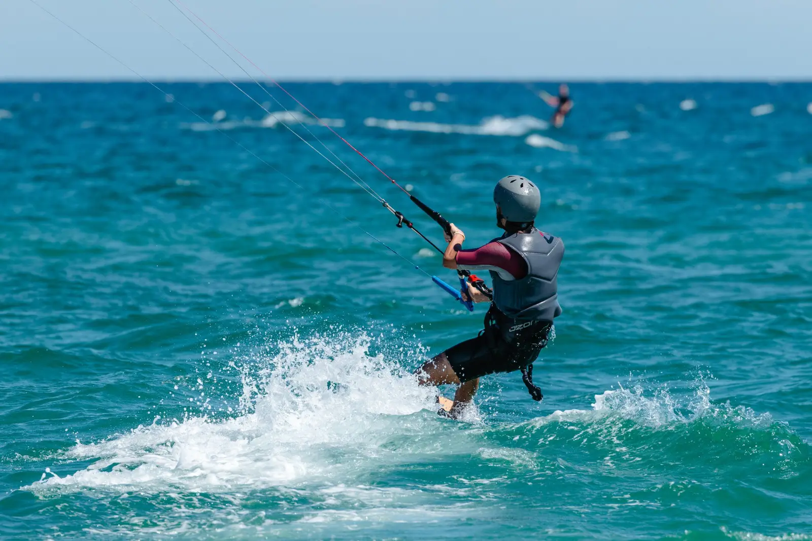 Kitesurfer gliding over the turquoise water off Cabanas de Tavira island