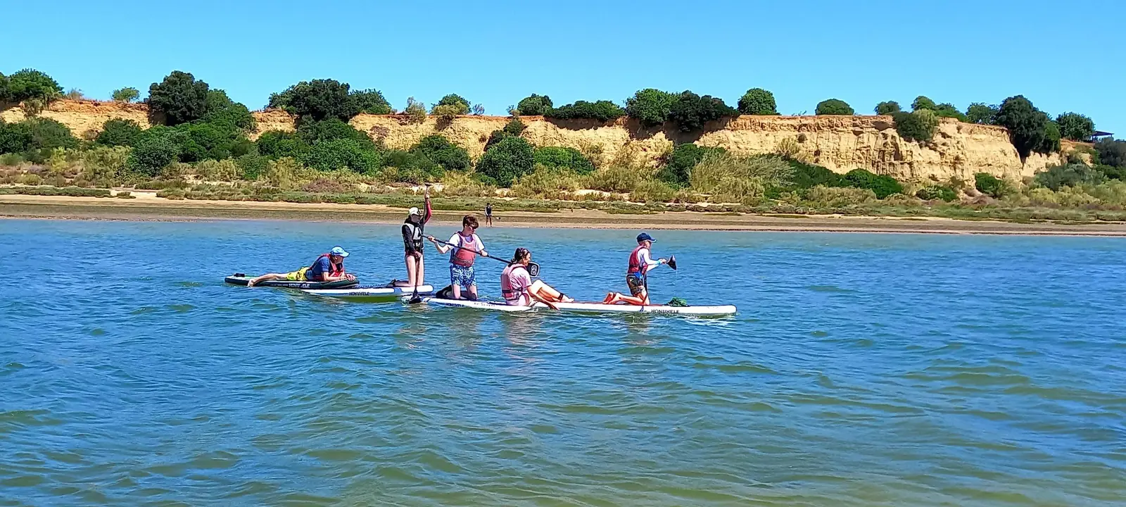 Team on a giant paddleboard in the Ria Formosa